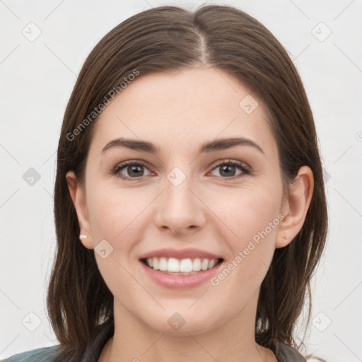 Joyful white young-adult female with medium  brown hair and grey eyes