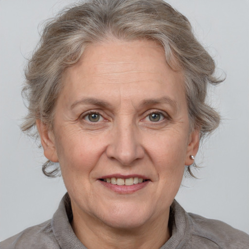 Joyful white middle-aged female with medium  brown hair and grey eyes