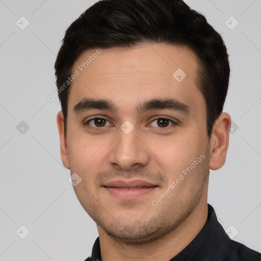 Joyful white young-adult male with short  black hair and brown eyes