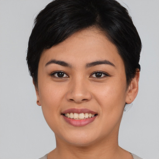 Joyful asian young-adult female with short  black hair and brown eyes