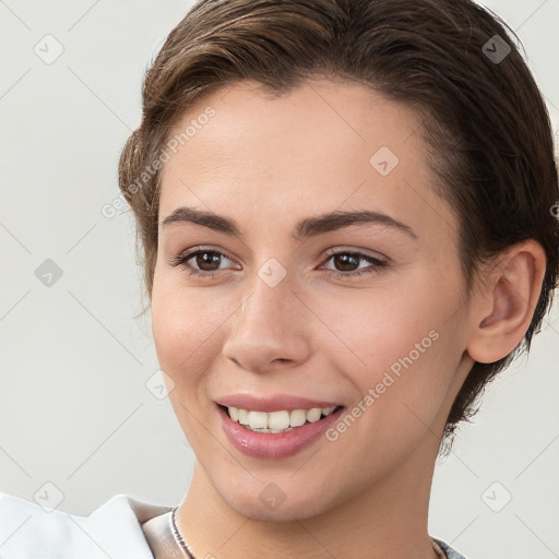 Joyful white young-adult female with short  brown hair and brown eyes