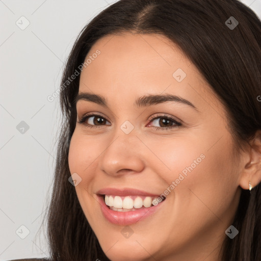 Joyful white young-adult female with long  brown hair and brown eyes