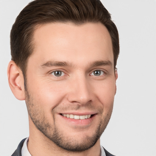 Joyful white young-adult male with short  brown hair and brown eyes