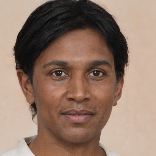 Joyful asian adult male with short  brown hair and brown eyes
