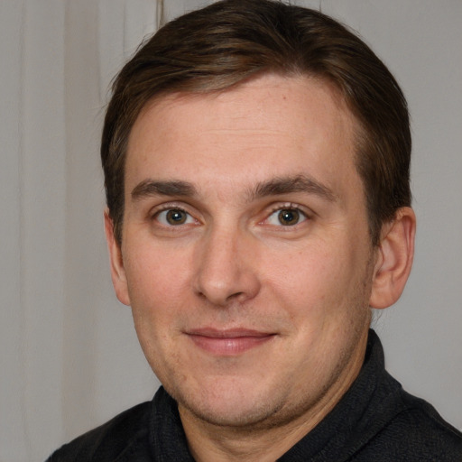 Joyful white adult male with short  brown hair and brown eyes