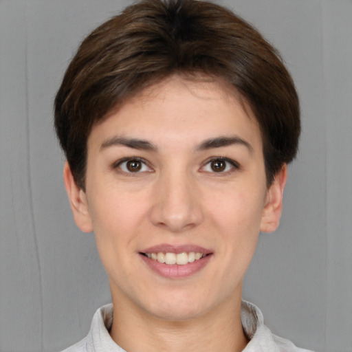 Joyful white young-adult female with short  brown hair and brown eyes