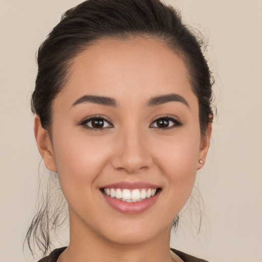 Joyful white young-adult female with long  brown hair and brown eyes