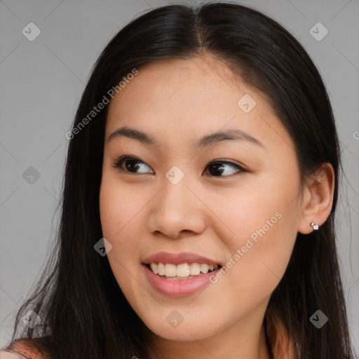 Joyful asian young-adult female with long  brown hair and brown eyes