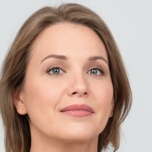 Joyful white adult female with medium  brown hair and grey eyes