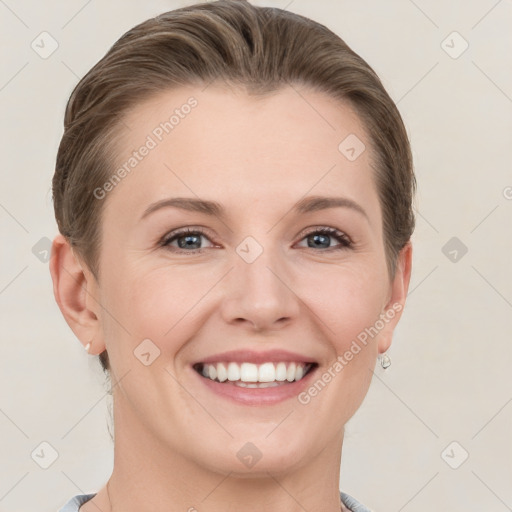 Joyful white young-adult female with short  brown hair and grey eyes