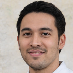 Joyful white young-adult male with short  black hair and brown eyes