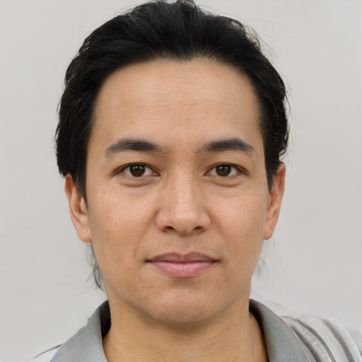 Joyful asian adult male with short  black hair and brown eyes