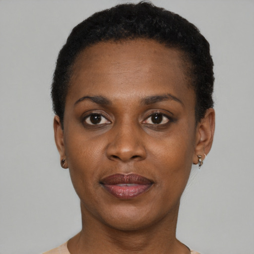 Joyful black young-adult female with short  black hair and brown eyes