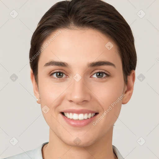 Joyful white young-adult female with short  brown hair and brown eyes