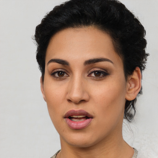Joyful latino young-adult female with short  brown hair and brown eyes