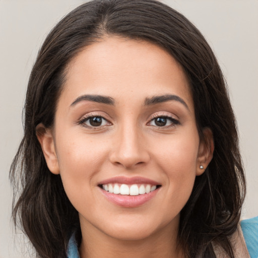 Joyful white young-adult female with long  brown hair and brown eyes