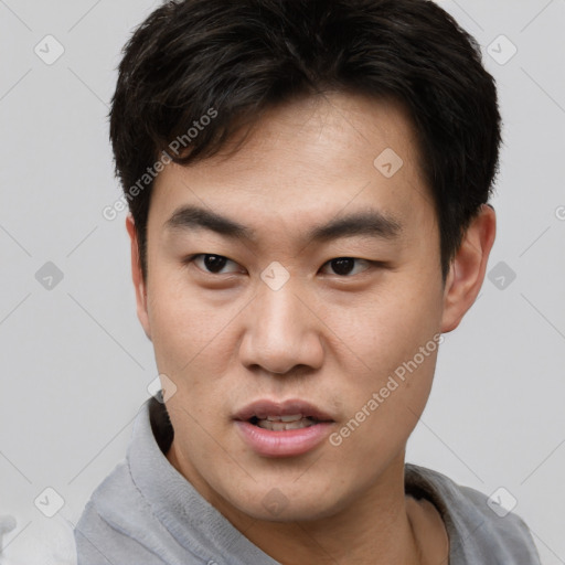 Joyful white young-adult male with short  black hair and brown eyes