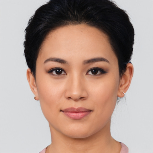 Joyful latino young-adult female with short  black hair and brown eyes