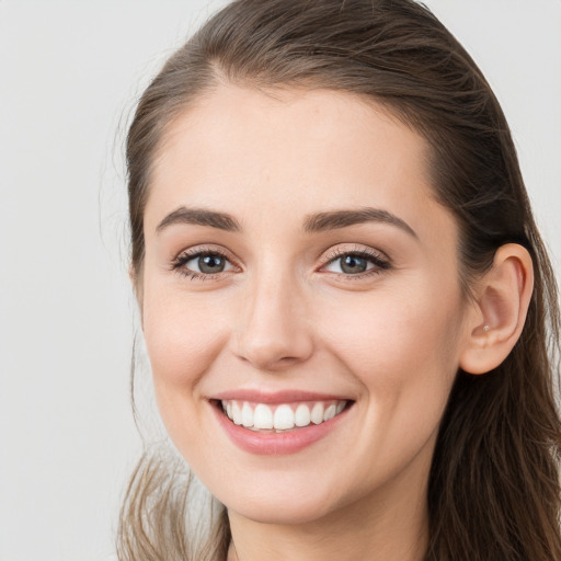 Joyful white young-adult female with long  brown hair and grey eyes