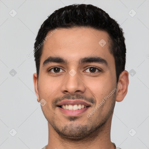 Joyful latino young-adult male with short  black hair and brown eyes