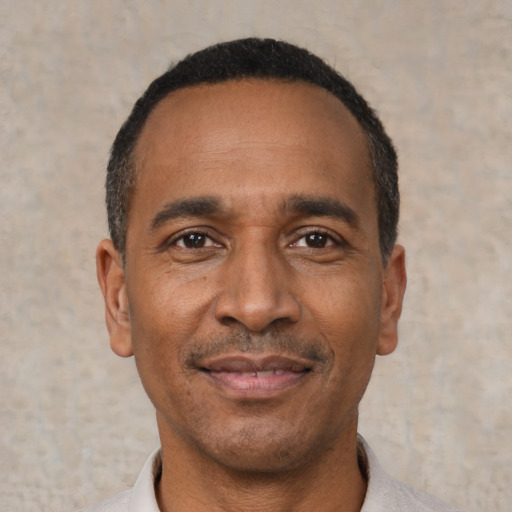 Joyful latino adult male with short  black hair and brown eyes