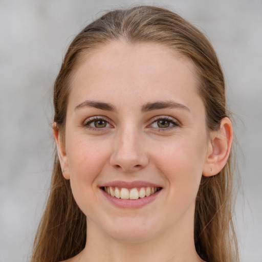 Joyful white young-adult female with long  brown hair and grey eyes