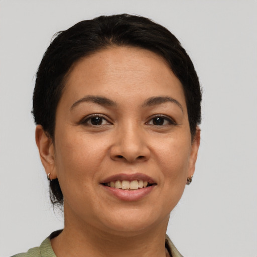 Joyful latino adult female with short  brown hair and brown eyes