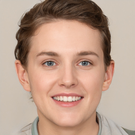 Joyful white young-adult female with short  brown hair and grey eyes