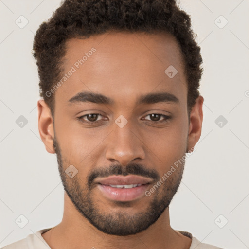 Joyful black young-adult male with short  brown hair and brown eyes