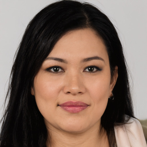 Joyful latino young-adult female with long  black hair and brown eyes