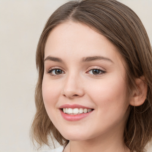 Joyful white young-adult female with medium  brown hair and green eyes