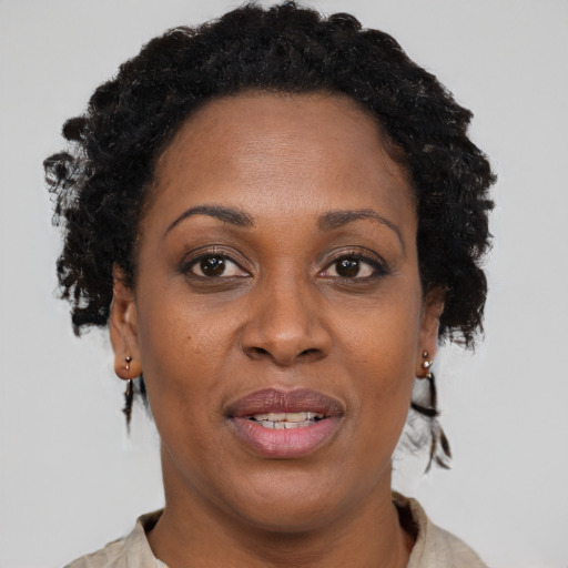 Joyful black adult female with short  brown hair and brown eyes