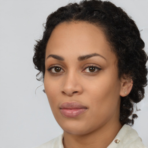 Joyful black young-adult female with medium  brown hair and brown eyes