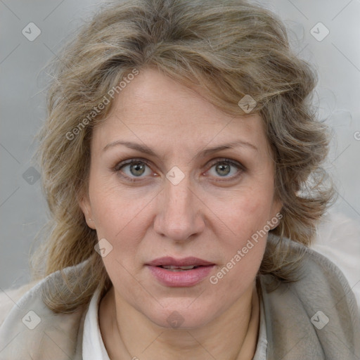 Joyful white adult female with medium  brown hair and blue eyes