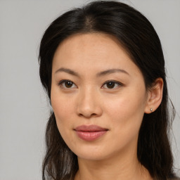 Joyful asian young-adult female with long  brown hair and brown eyes