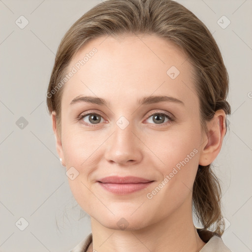 Joyful white young-adult female with medium  brown hair and grey eyes