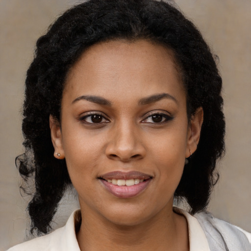 Joyful black young-adult female with medium  brown hair and brown eyes