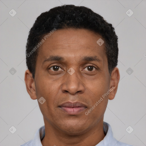 Joyful latino adult male with short  black hair and brown eyes