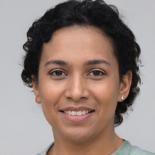 Joyful latino young-adult female with short  brown hair and brown eyes