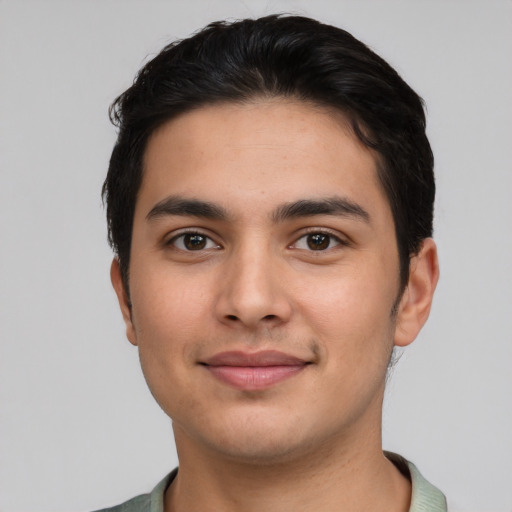 Joyful latino young-adult male with short  brown hair and brown eyes