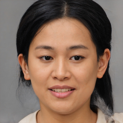 Joyful asian young-adult female with medium  black hair and brown eyes