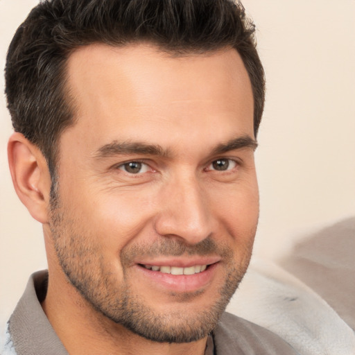 Joyful white young-adult male with short  brown hair and brown eyes