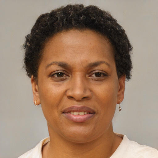 Joyful black adult female with short  brown hair and brown eyes