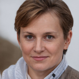 Joyful white adult female with medium  brown hair and brown eyes