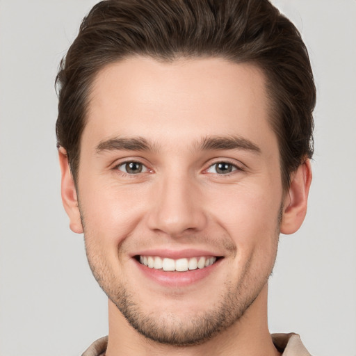 Joyful white young-adult male with short  brown hair and brown eyes