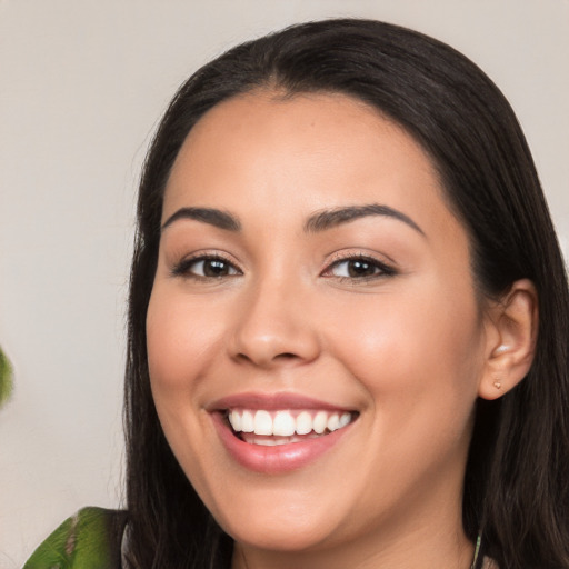 Joyful white young-adult female with long  black hair and brown eyes