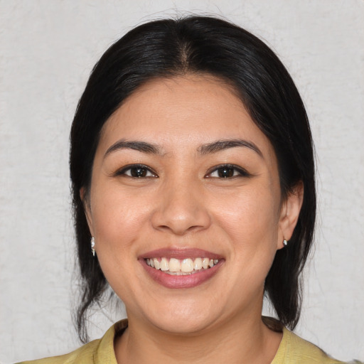 Joyful asian young-adult female with medium  black hair and brown eyes