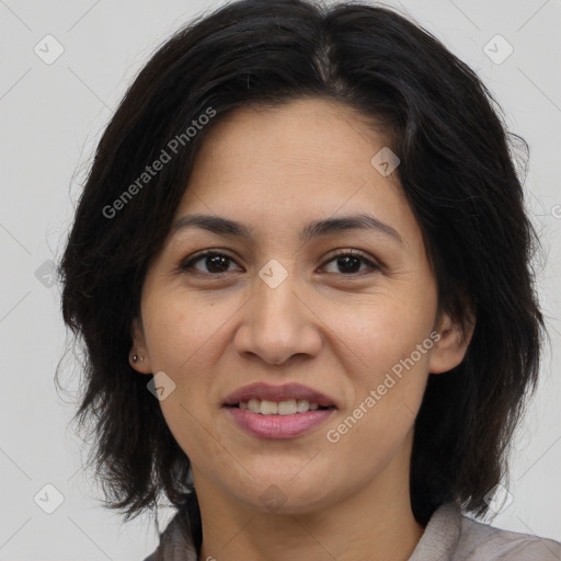 Joyful asian adult female with medium  brown hair and brown eyes