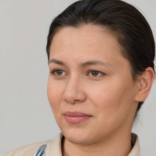 Joyful white adult female with short  brown hair and brown eyes