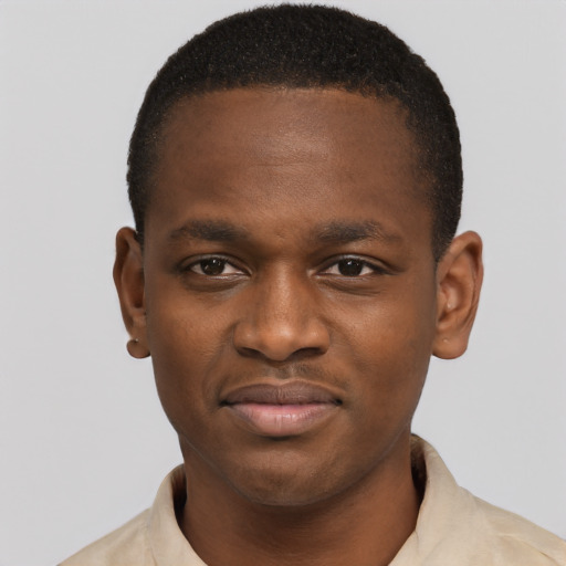 Joyful black young-adult male with short  brown hair and brown eyes